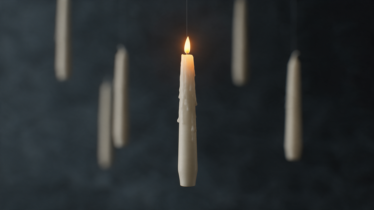 Close-up of a Hollowick candle floating with a warm flickering LED flame