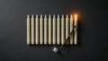 Hollowick floating candle set: ivory LED taper candles, wand remote, clear hanging line and ceiling hooks on dark slate